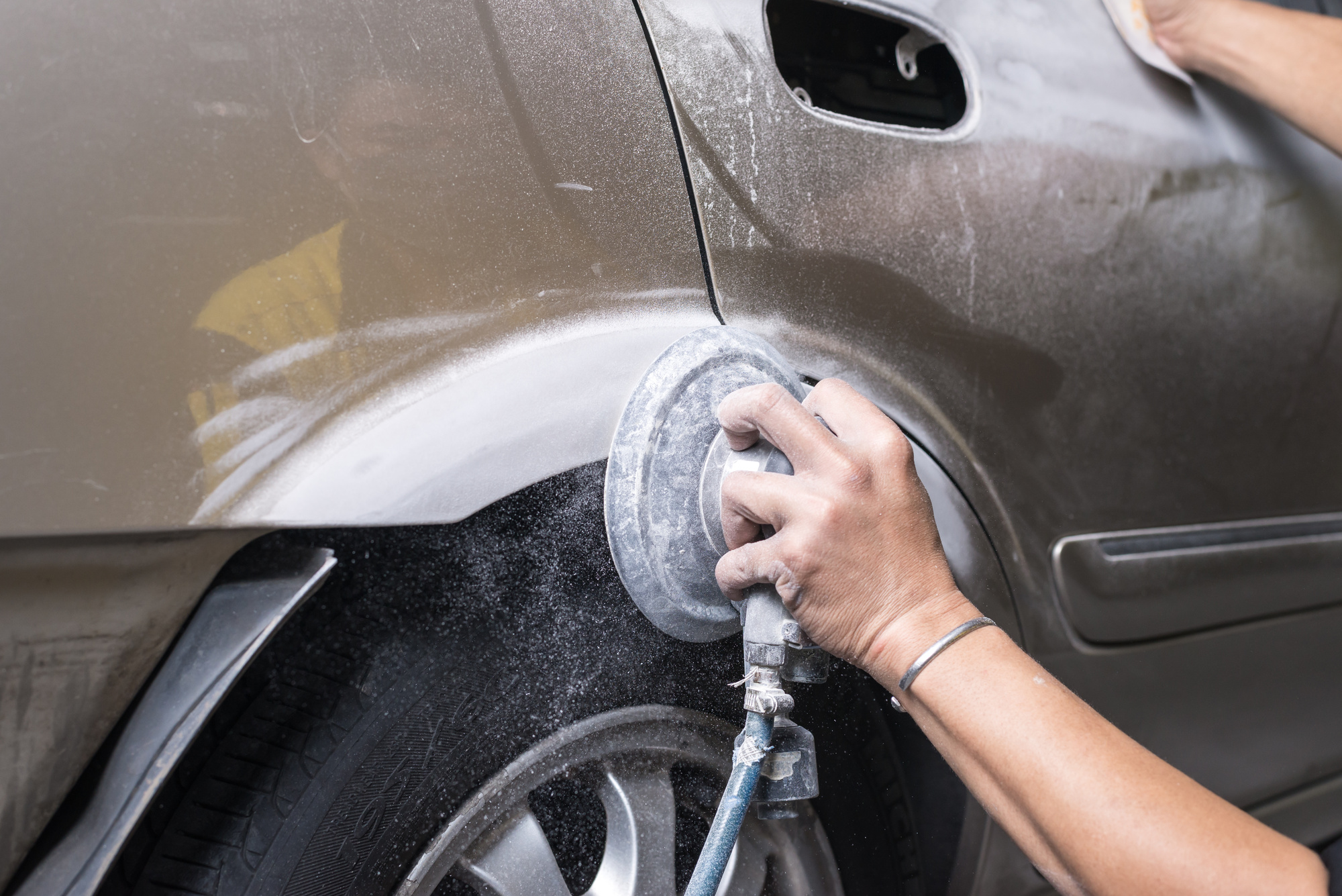 person repairing car dent