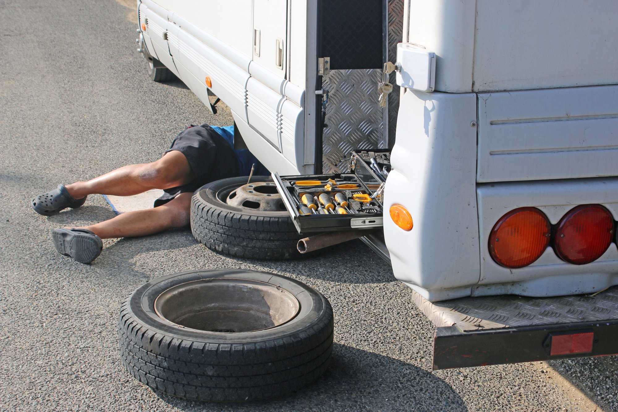 man repairing RV