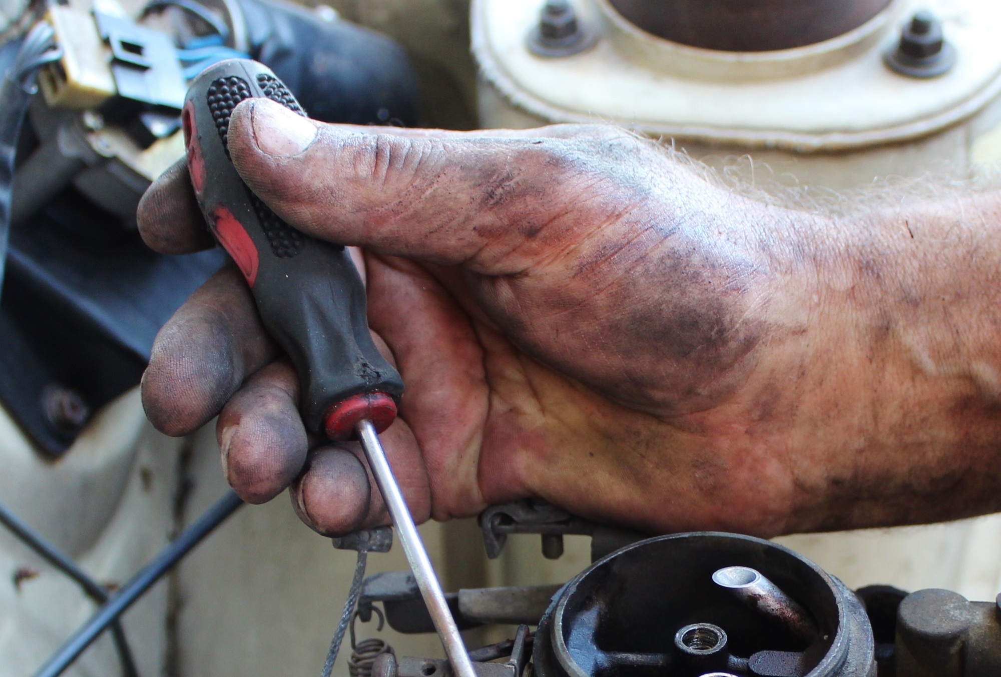 mechanic's hand with screwdriver