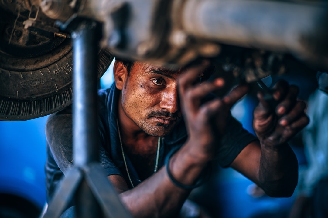 man repairing brakes