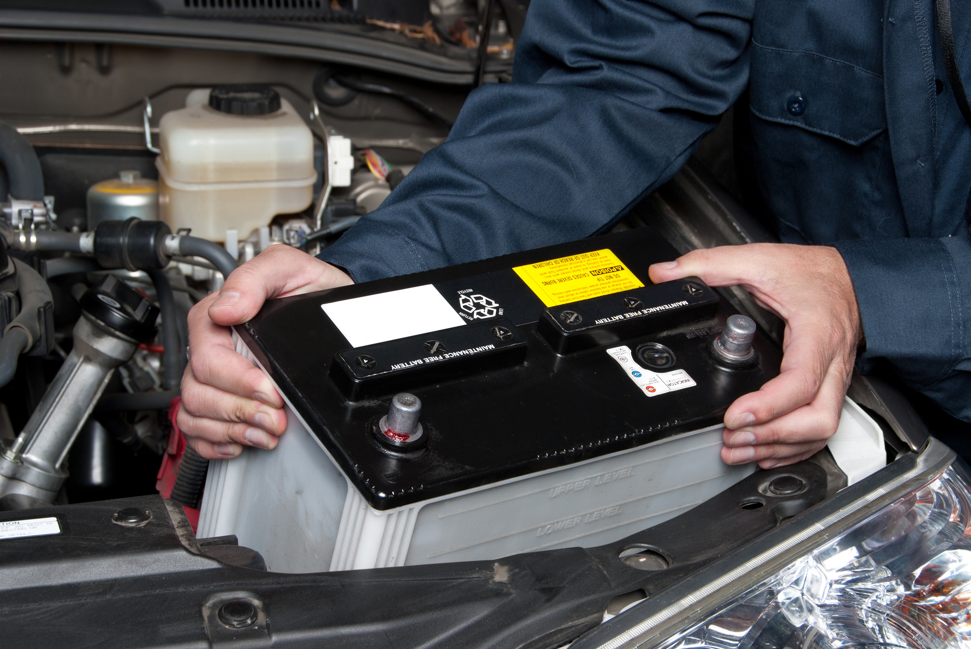 Mechanic Replacing a Car's Battery